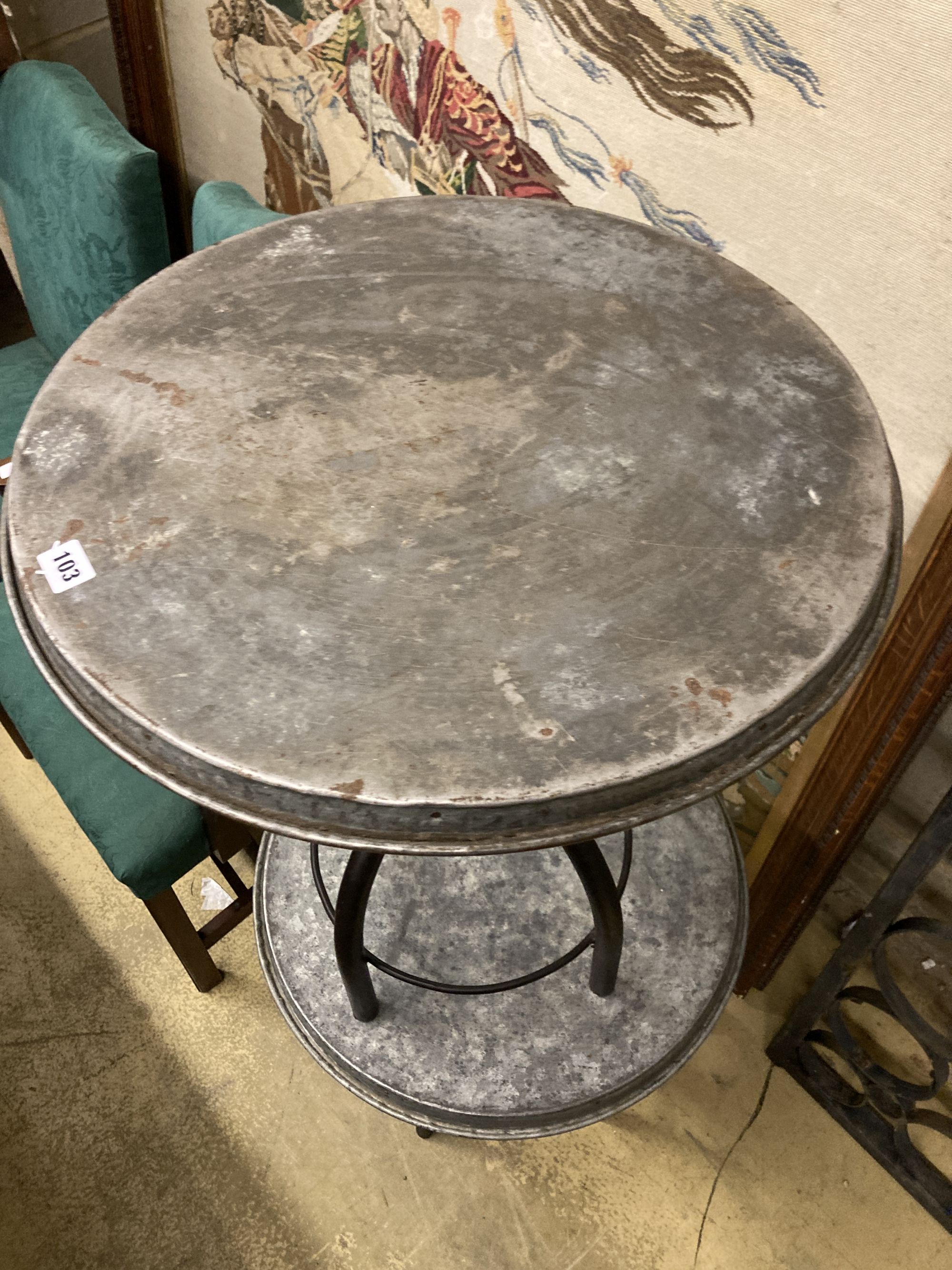 A pair of industrial style circular metal and wrought iron occasional tables, 54cm diameter, height 65cm